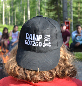 Camp Got2Go Youths gathered around campfire